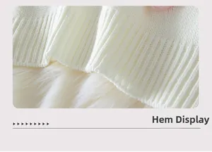 Detail view of the ribbed hem on this cream knit strawberry sweater for women