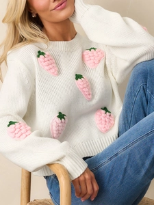 White crew neck sweater with 3D strawberry embroidery and pink knitted details