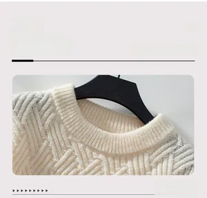 Detailed view of cream cable knit texture and ribbed crew neck on this winter sweater
