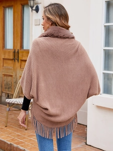 Detailed back view of brown knit shawl featuring faux fur collar and fringe tassels