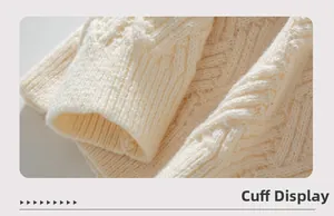 Macro shot of cable-knit texture and ribbed cuffs on a cream-white knit sweater