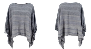 Detail of grey striped knit poncho featuring long tassels and soft textured fabric