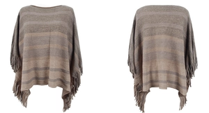 Detail of knit poncho featuring earth-tone stripes and long fringe tassels on the hem
