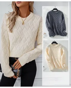 Close-up detail of the cable knit texture and ribbed crew neck on this winter sweater