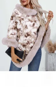 Detail of faux fur collar and textured leopard print knit fabric on women's winter poncho
