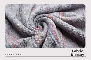 Macro shot of soft grey knit fabric with colorful stripes and woven texture detail