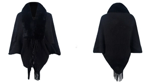Detailed view of black knitted poncho featuring a plush faux fur collar and fringed hem