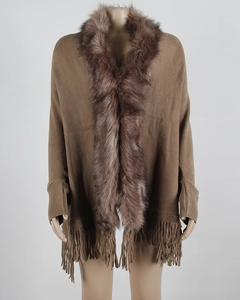 Detail of knit brown shawl featuring faux fur collar and decorative fringe hemline