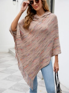 Detailed view of striped hooded poncho featuring long tassel fringe and soft knit texture
