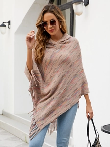 Close-up of multicolored knit poncho showing hooded design and long fringe tassels