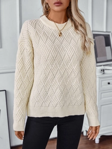Detailed view of off-white chunky cable knit sweater featuring classic chevron texture