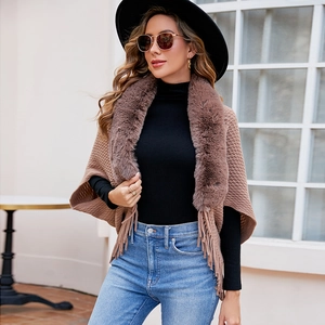 Women's brown knit poncho cloak with a luxury faux fur collar and tassel hem detail