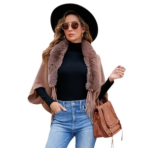 Brown knitted poncho featuring a faux fur collar and long tassel trim for autumn and winter