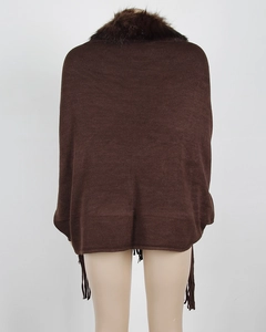 Close-up of thick dark brown faux fur collar and knit tassels on a winter poncho cape