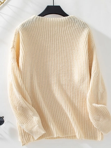 Detailed cable knit pattern on loose long sleeve cream white pullover sweater