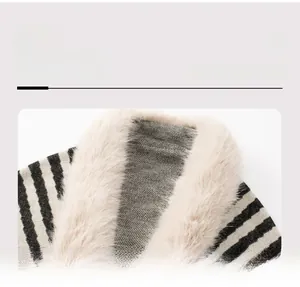 Detail view of the soft faux fur collar and striped knit texture on this winter poncho
