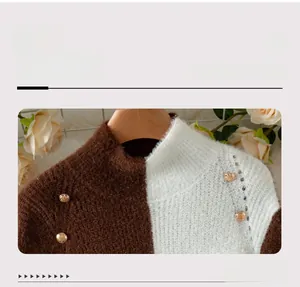 Detail of knit sweater neckline with two-tone patchwork and decorative buttons