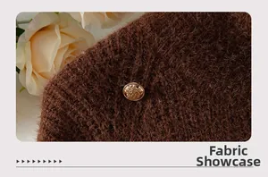 Macro view of dark brown plush knit fabric featuring a vintage gold crown metal button