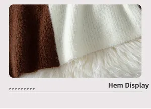 Detailed hem view of two-tone knit sweater featuring fluffy brown and cream mohair fabric