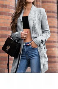 Street style view of a grey longline waffle knit cardigan with side pockets