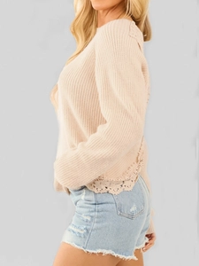 Elegant beige knit sweater with delicate lace trim and ribbed texture for a chic look