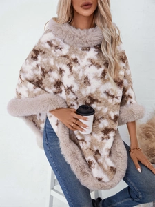 Detail of loose leopard knit poncho with plush faux fur collar and fringed hem design