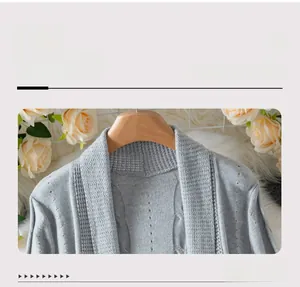 Macro detail of soft grey knit cardigan collar with hollow patterns and ribbed texture