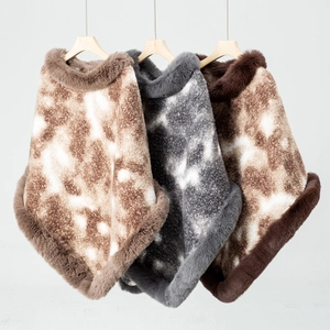 Detail of faux fur collar and textured leopard print ponchos in three neutral colors