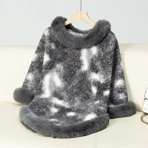 Detail of grey leopard knit poncho with luxurious faux fur trim on collar and cuffs