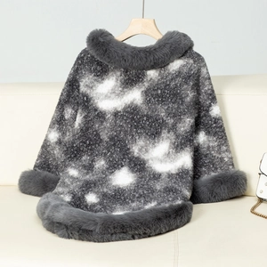 Detail of gray and white tie-dye knit poncho with faux fur collar on wooden hanger