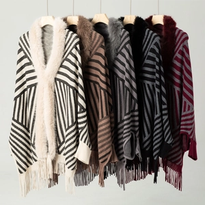Detail of striped knit shawls with plush faux fur collars and fringe in five colors
