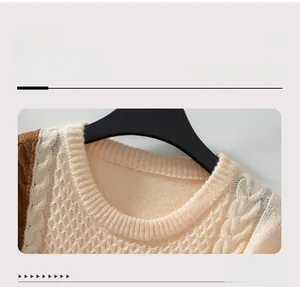 Detail of color-block knit sweater showing cable knit and honeycomb stitch texture