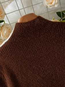 Close-up of the plush chocolate brown knit fabric with soft mohair texture and round neck