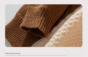 Close-up of ribbed cuffs on chunky knit sweaters in brown and cream white tones
