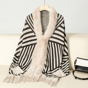 Detail of knit shawl featuring soft faux fur collar, striped patterns and fringe trim