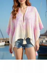 Detailed knit texture and white tassel fringe on pink gradient bohemian poncho