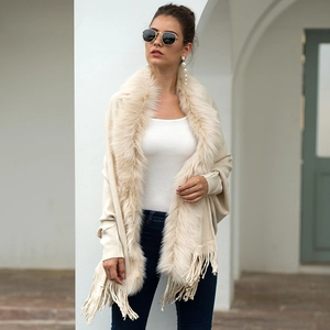 Elegant beige knit poncho with luxury faux fur collar and long tassels for women