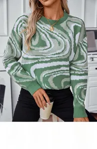 Detail of green and white marble jacquard pattern on a loose knit women sweater