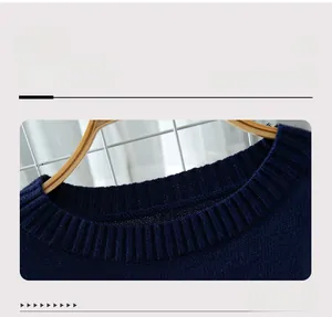 Close-up of the dark blue ribbed knit neckline and texture on this cropped sweater