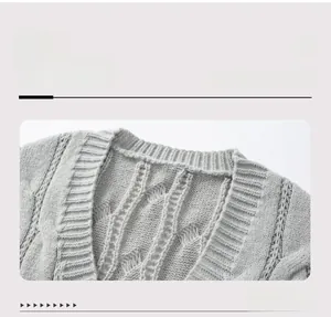 Detailed view of the neckline and cable knit texture on a light grey women's cardigan