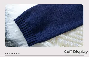 Detail view of ribbed cuff on dark blue knitted sweater with needlework textures