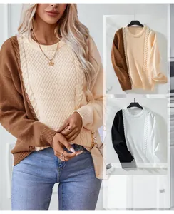 Detail of cable knit pattern and color block texture on women's crewneck sweater