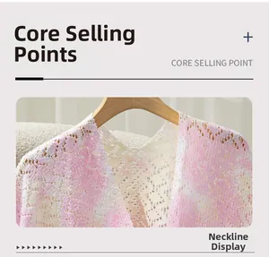 Close-up of V-neckline on pink and white bohemian lace hollow knit shawl with fringe