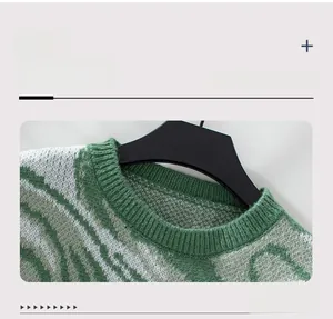 Close-up of the round neckline on a green wavy jacquard knit sweater with fine textures