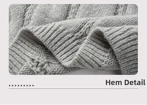 Detail view of the chunky cable knit hem on this oversized gray cardigan sweater