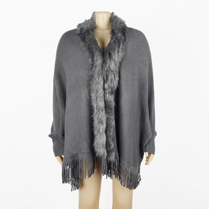 Gray knitted poncho cape with elegant faux fur collar and long fringe hem detail