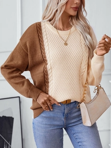 Close-up of cable knit texture on a color-block crewneck sweater in brown and beige
