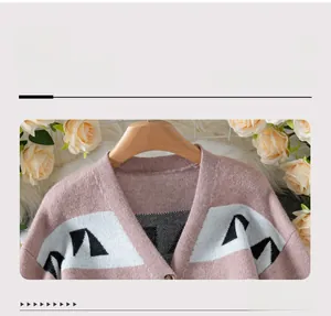 Detail of V-neckline on dusty pink jacquard knit cardigan with geometric pattern