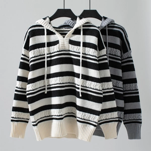 Detail of drawstring hood and wavy knit texture on a striped pullover sweater