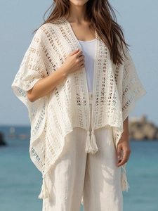 Beige crochet hollow out knit poncho shawl with fringe details for beach vacation style